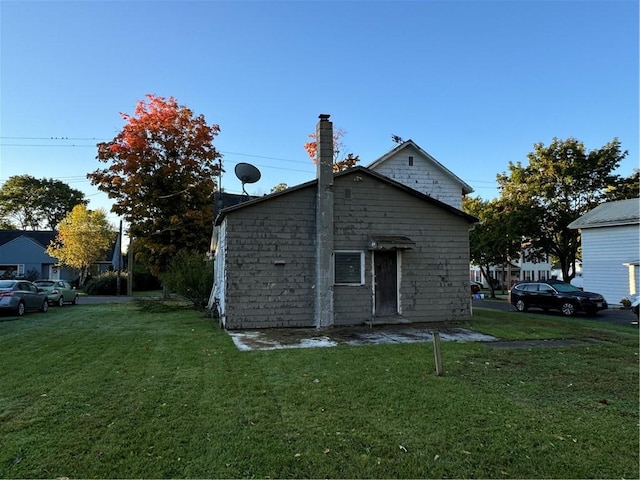 view of property exterior with a yard