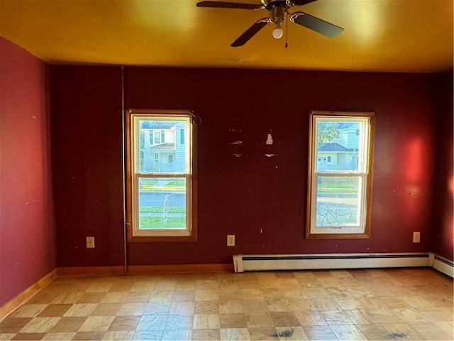 spare room with ceiling fan and a baseboard heating unit