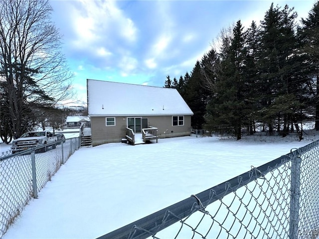 view of snow covered back of property