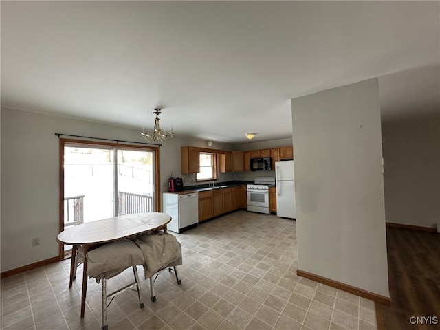 dining area featuring a chandelier and sink