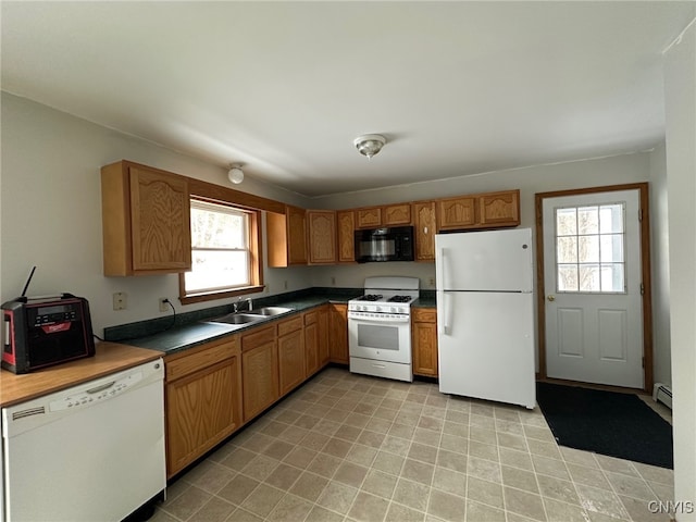 kitchen with sink, white appliances, and a baseboard radiator