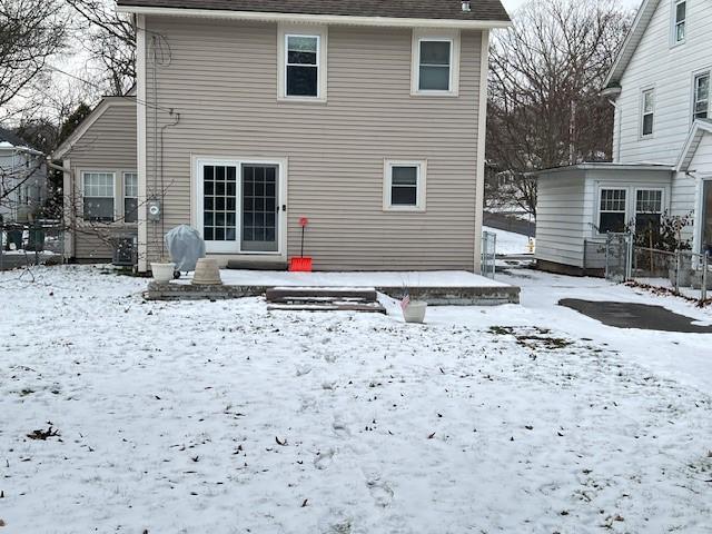 view of snow covered rear of property