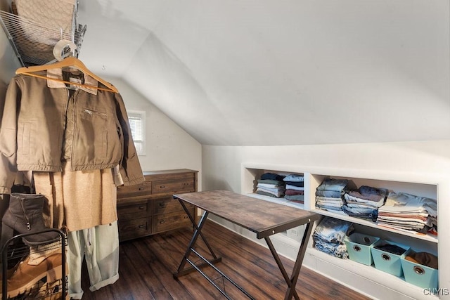 walk in closet with dark hardwood / wood-style flooring and vaulted ceiling