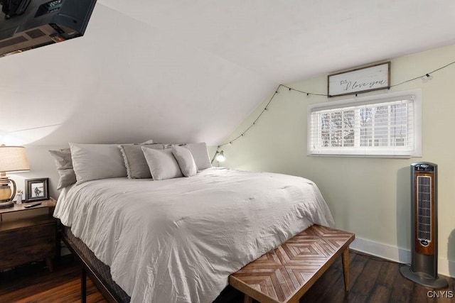 bedroom with lofted ceiling and dark hardwood / wood-style flooring