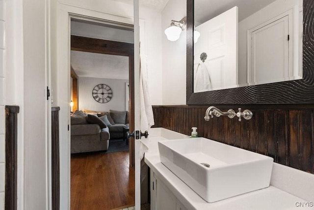 bathroom featuring wood-type flooring, vanity, and beam ceiling