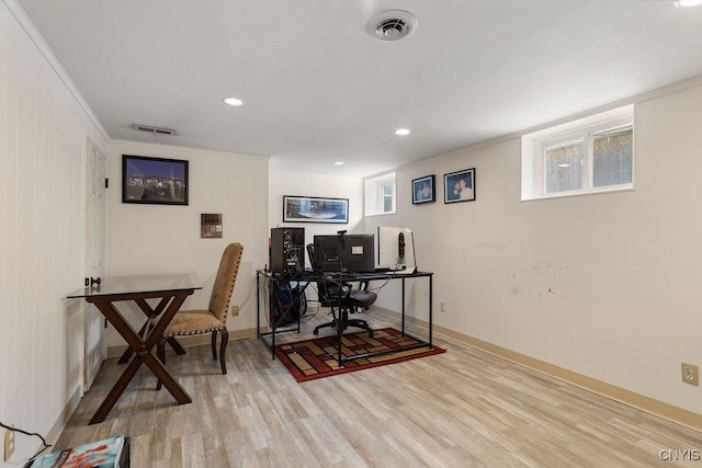 office area with light wood-type flooring and crown molding