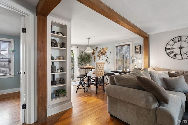 living room with a healthy amount of sunlight, hardwood / wood-style flooring, and built in features