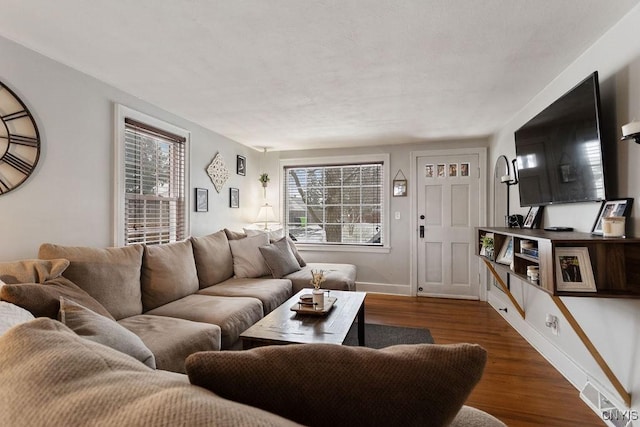 living room with a healthy amount of sunlight and dark hardwood / wood-style floors