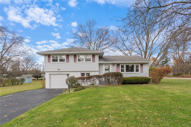 tri-level home featuring a front yard and a garage