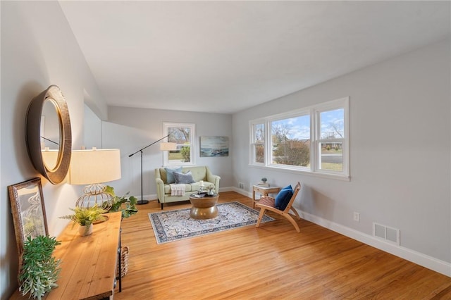 sitting room with hardwood / wood-style flooring