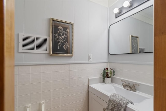 bathroom featuring tile walls and vanity