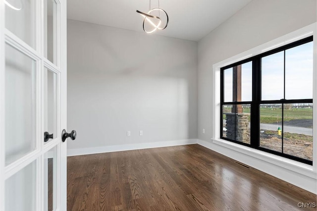 unfurnished room with dark wood-type flooring and french doors