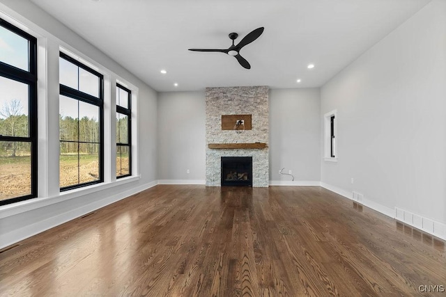 unfurnished living room featuring ceiling fan, a fireplace, and hardwood / wood-style flooring