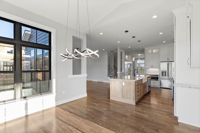 kitchen featuring white cabinetry, tasteful backsplash, a spacious island, pendant lighting, and appliances with stainless steel finishes