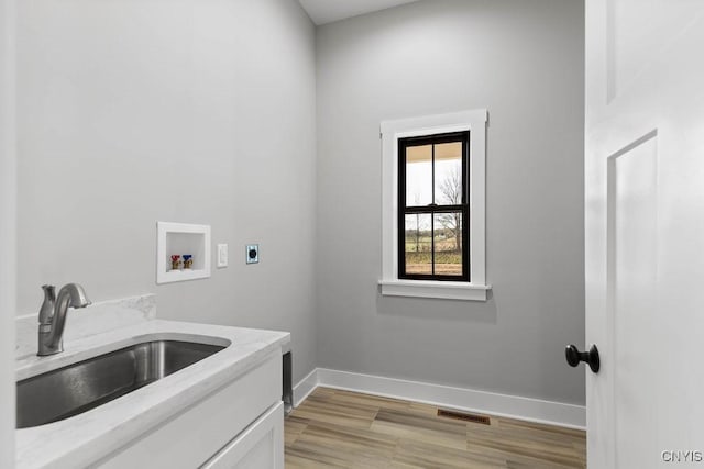 laundry room with sink, cabinets, hookup for an electric dryer, and washer hookup