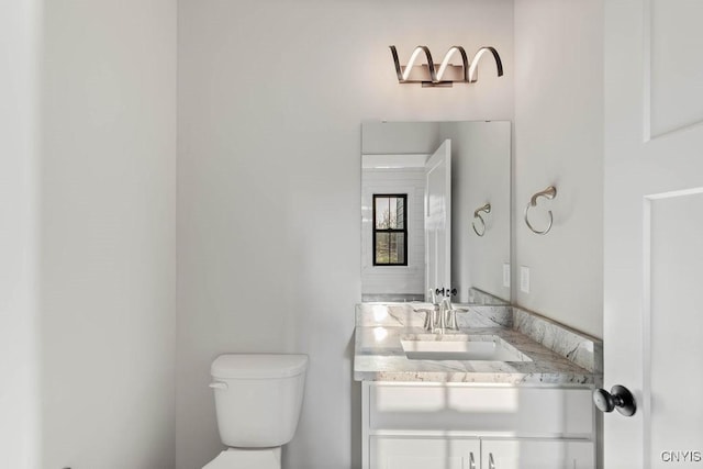 bathroom with toilet and vanity