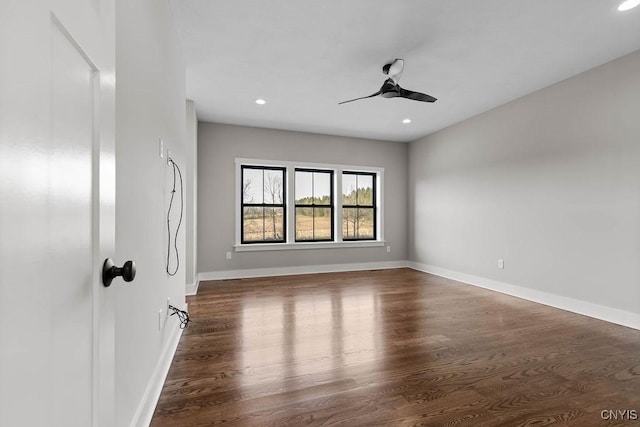 unfurnished room with ceiling fan and dark hardwood / wood-style floors