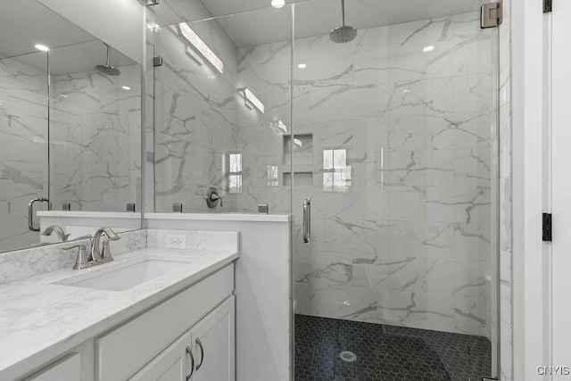 bathroom with vanity and a shower with shower door