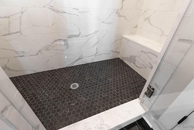 bathroom with a tile shower