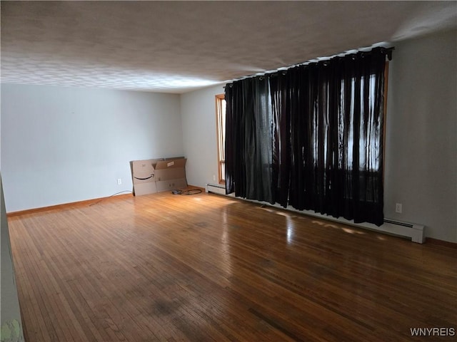 spare room with hardwood / wood-style floors