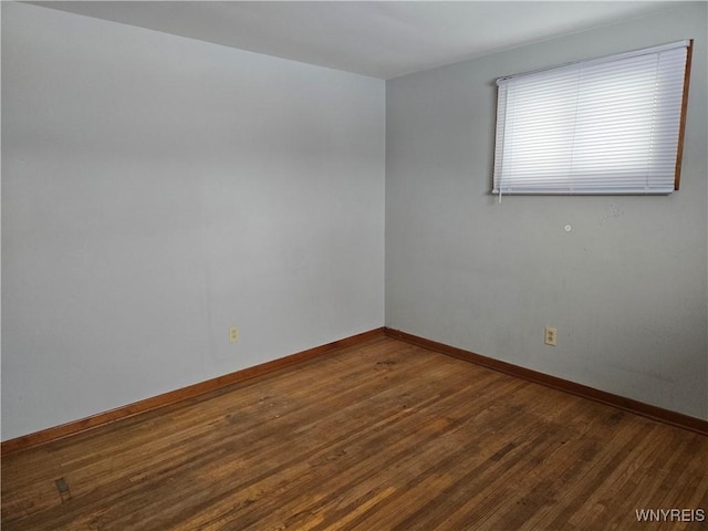 empty room featuring dark hardwood / wood-style flooring