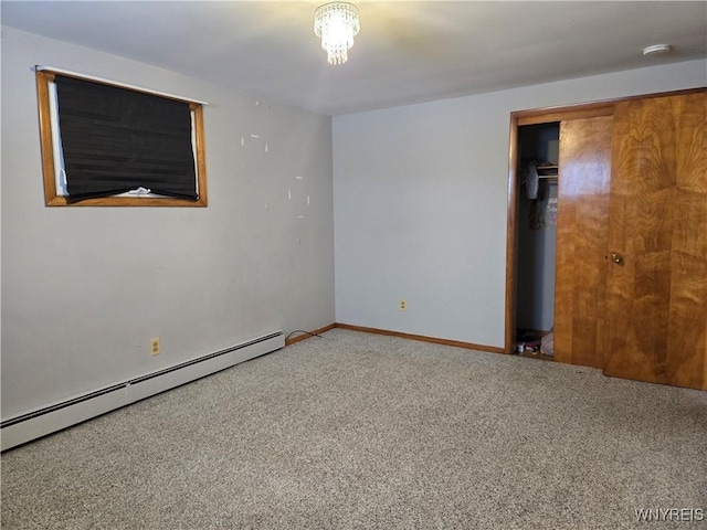 empty room featuring a baseboard radiator and carpet flooring