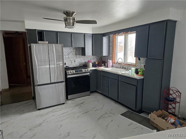 kitchen featuring decorative backsplash, gray cabinets, appliances with stainless steel finishes, ceiling fan, and sink