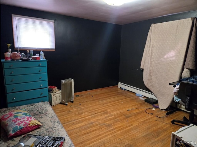 bedroom with light wood-type flooring and radiator heating unit