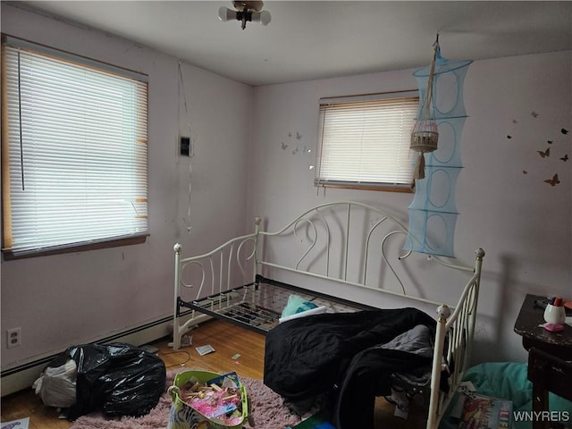 bedroom featuring hardwood / wood-style floors and multiple windows