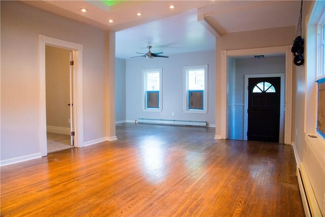 entryway featuring a baseboard radiator, ceiling fan, and hardwood / wood-style flooring