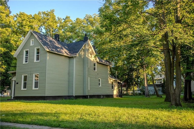 view of home's exterior with a yard