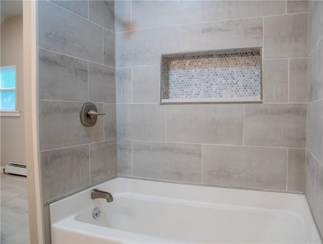 bathroom with baseboard heating and tiled shower / bath combo