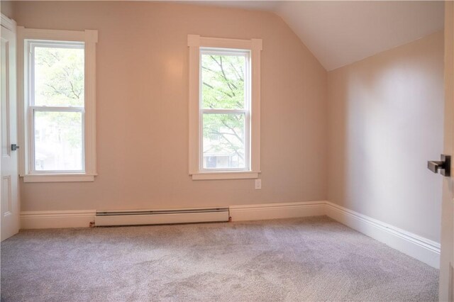 additional living space featuring lofted ceiling, a baseboard heating unit, and light colored carpet