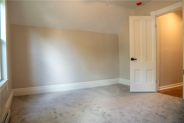 unfurnished room featuring a baseboard heating unit