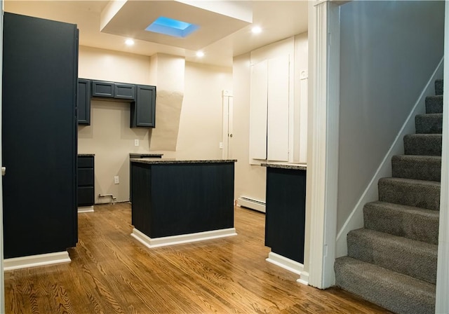 kitchen with baseboard heating and wood-type flooring