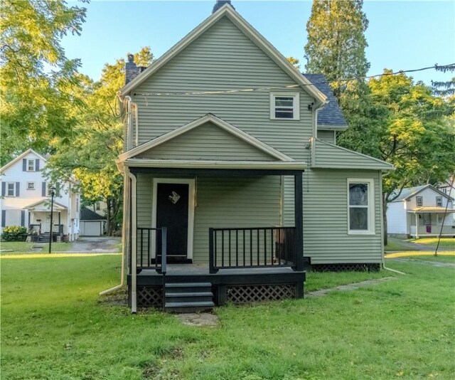 rear view of property with a yard