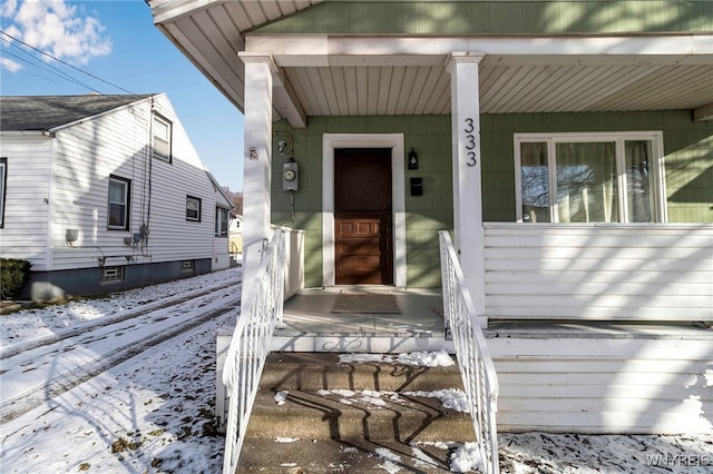 view of snow covered property entrance