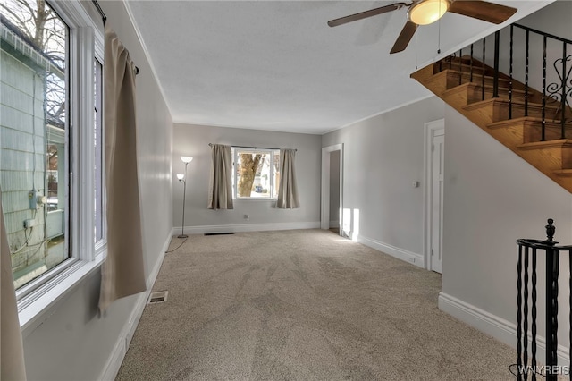 carpeted empty room featuring ceiling fan