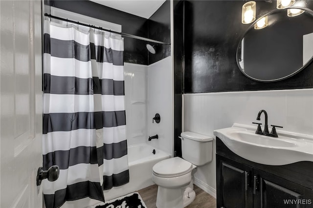 full bathroom featuring toilet, hardwood / wood-style flooring, shower / bath combo, and vanity