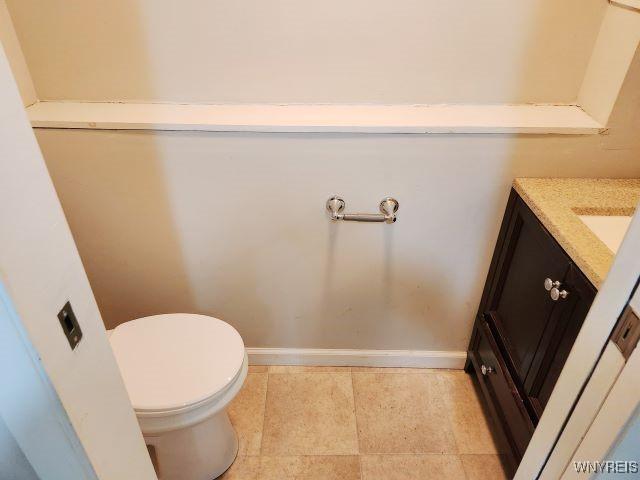 bathroom featuring toilet and vanity