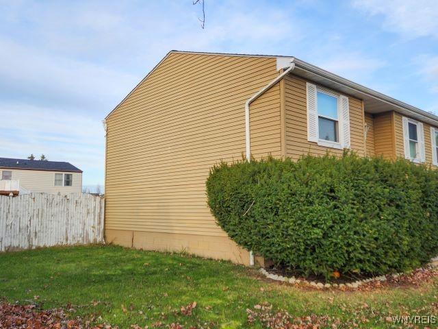 view of side of home with a lawn