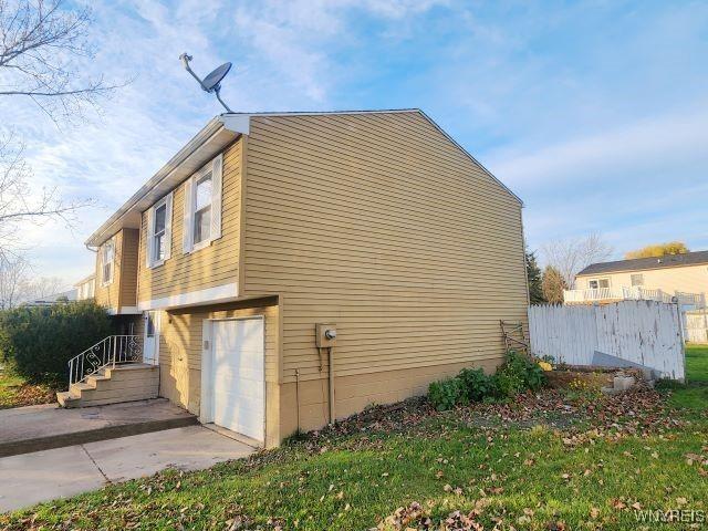 view of side of home featuring a garage