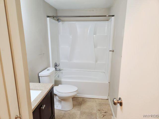 full bathroom featuring toilet, vanity, and  shower combination