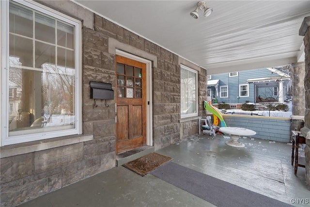 property entrance featuring covered porch