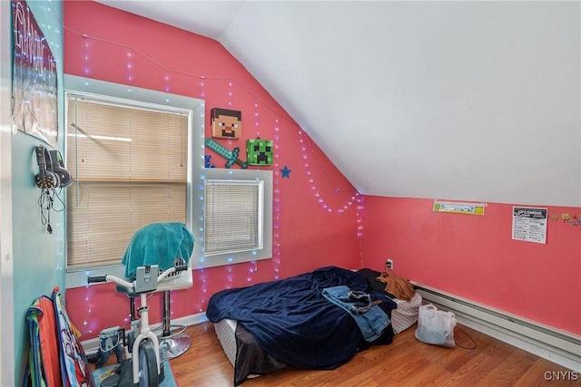 bedroom with baseboard heating, vaulted ceiling, and hardwood / wood-style flooring