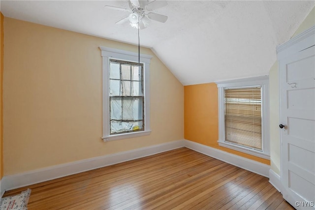 bonus room featuring ceiling fan, light hardwood / wood-style flooring, and lofted ceiling