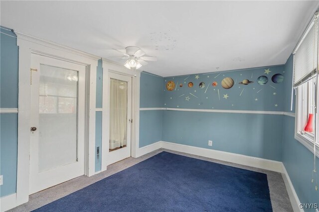 carpeted spare room with ceiling fan