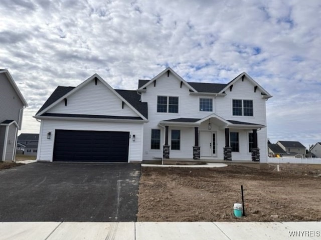 view of front of property with covered porch and a garage