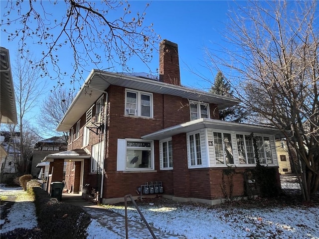 snow covered property with cooling unit