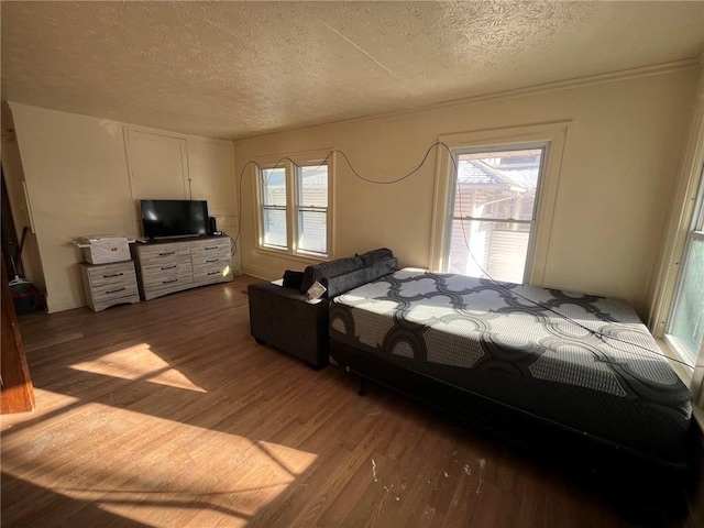 bedroom featuring a textured ceiling and hardwood / wood-style floors